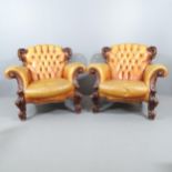 A pair of 19th century continental oak and button-back studded leather upholstered baroque armchairs