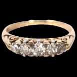 An unmarked gold diamond set five stone dress ring, size M