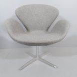 A mid-century style swivel lounge chair in the manner of the Arne Jacobsen Swan chair.
