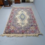 A cream-ground Kerman rug. 220x140cm