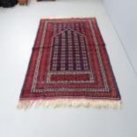 A red-ground Persian prayer rug. 186x112cm.