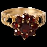 A 9ct engraved gold and garnet set flowerhead design dress ring, size P