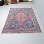 An antique red and blue-ground Persian prayer rug. 195x137cm.