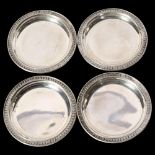 A set of 4 small silver dishes, with embossed edge, all marked 29po