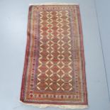 A hand made red-ground Bokhara rug. 183x99cm.
