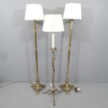 A pair of 1920s brass standard lamps, height to bayonet fitting 138cm, and another (3).