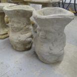 A pair of concrete planter/umbrella stands in the form of toby jugs. 30x43cm