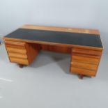 A mid-century Danish style teak twin-pedestal desk, with embossed black leather skiver, modesty