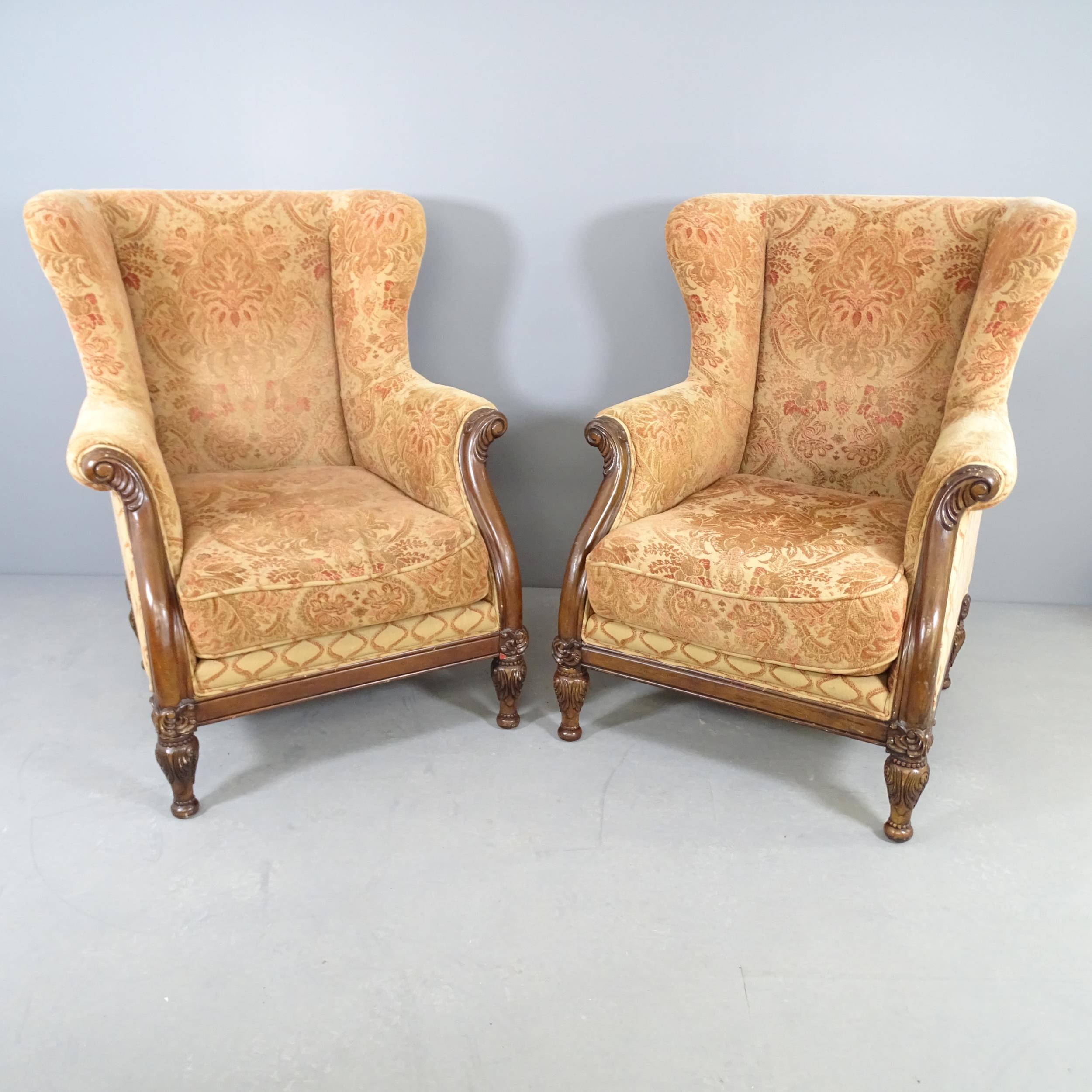 A pair of mahogany and upholstered George III style wingback armchairs. Overall 89x112x95cm, seat