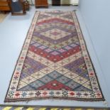 An antique Kilim rug. 312x140cm.
