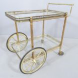 A mid-century design French brass and glass two-tier drinks trolley in the manner of Maison