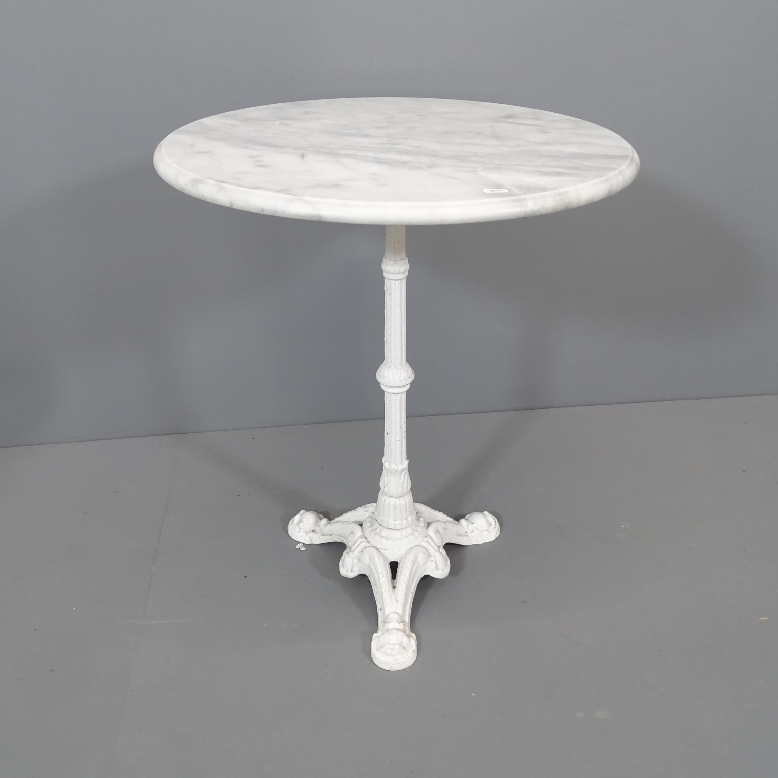 A circular marble top garden table on white painted cast iron base. 60x74cm