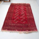A red-ground Turkaman rug. 204x130cm.