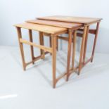 A mid-century Danish teak nest of three occasional tables with label for BC Mobler. Largest