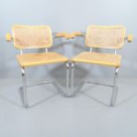 A pair of similar mid-century design cantilever armchairs with cane panelled back and seat, in the
