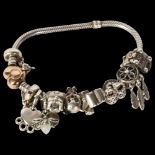 A Pandora silver charm bracelet with 10 charms, including some Disney ones, and heart-shaped clasp