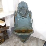 A painted cast iron lion mounted water feature. 42x78x20cm.