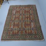 A cream-ground Kerman rug. 232x165cm