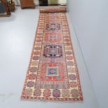 A cream-ground Caucasian runner. 422x82cm.