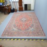 A red-ground Kashan carpet. 305x203cm