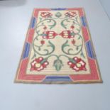 A handmade folk-art tulip design rug. 180x104cm.