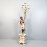 A 19th Century polychrome painted and parcel gilt Blackamoor style floor standing torchere. Height
