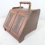 A Victorian mahogany coal scuttle, with opening mechanism to two doors, applied carved panels, liner