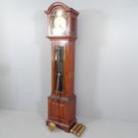 A late 20th century oak cased eight day longcase clock, with 10.5" arch top brass dial inscribed "