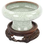 A Chinese celadon crackle glaze Ge-type stemmed bowl, diameter 16cm, on carved wood stand,