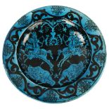 An Islamic blue ground glazed pottery bowl, decorated with hunting scenes, diameter 30cm