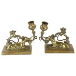 A pair of 19th century brass candlesticks surmounted by Greyhounds, base length 13cm