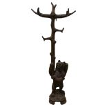 A Black Forest carved wood hall stand, supported by a bear with basket on his back, height 180cm
