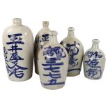 5 Japanese glazed ceramic bottles, with painted text, largest height 38cm