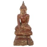 A Burmese gilded and lacquered carved wood Buddha, 17th or 18th century, height 29cm