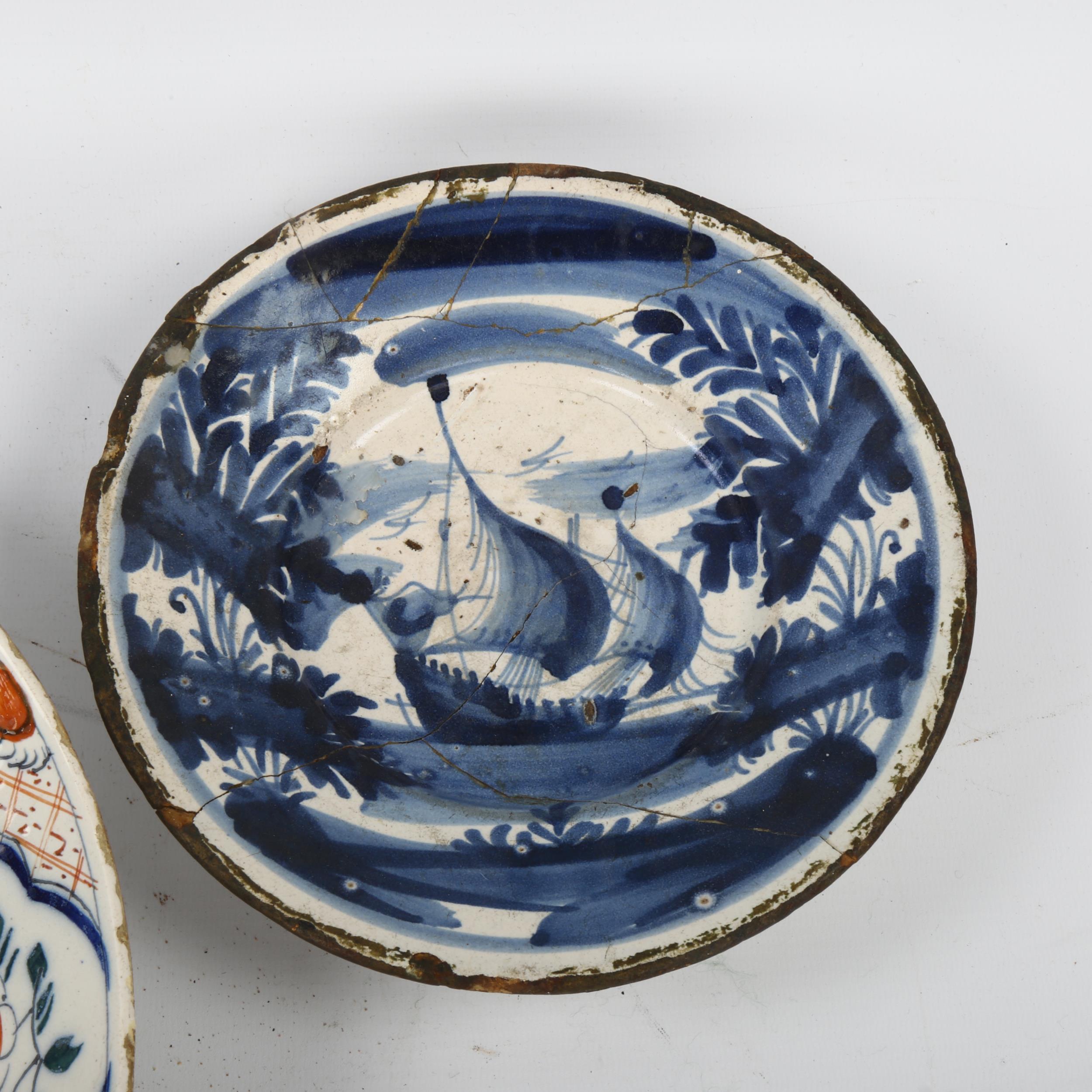 A tin-glazed pottery charger with painted decoration, diameter 24cm, and an early tin-glazed blue - Image 2 of 3