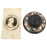 A 19th century black marble paperweight, inset with a band of specimen hardstone, diameter 10cm, and