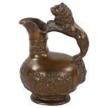 A 19th century heavy cast patinated bronze Roman style wine ewer, with lion handle and relief