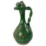 A Turkish Islamic Ottoman green glaze earthenware Canakkale ewer, height 36cm Surface paint/glaze