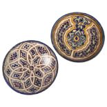 2 Moroccan Islamic pottery plates with painted decoration, diameter 22cm Minor paint chips on the