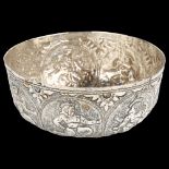 An Indian white metal bowl, with relief embossed deity decoration, diameter 13cm, 6oz Top edge has a