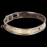 A Victorian silver dog collar, engraved floral decoration with leather lining and inscribed name