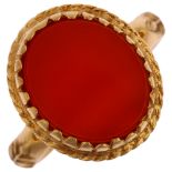 An Antique 9ct gold carnelian signet ring, with openwork scrolled bridge and raised leaf shank, 17.