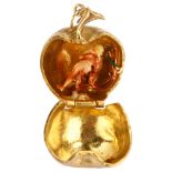 A mid-20th century 9ct gold Adam Eve and the Apple kinetic charm/pendant, opening to reveal enamel