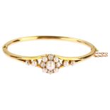 A Victorian cultured pearl and diamond cluster hinged bangle, unmarked 18ct gold settings with old-