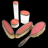 A George V Art Deco silver and pink celluloid 3-piece dressing table set, comprising hairbrush and 2