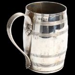A George III silver barrel pint mug, with reeded decoration and acanthus leaf reeded handle,