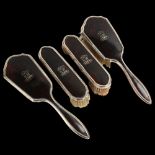 A George V Art Deco silver and tortoiseshell 4-piece dressing table set, comprising 2 x hairbrushes,