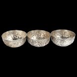 A set of 3 Thai white metal bowls, with relief embossed deity decoration, diameter 13cm, 21.6oz