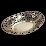 An Edwardian Art Nouveau silver cake basket, pierced stylised gallery with reeded rim, Charles S