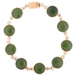 An early 20th century jade panel bracelet, unmarked rose gold closed-back settings, jade diameter